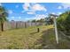Spacious backyard with a wooden fence and lush green grass at 106 Aurora E St, Venice, FL 34285