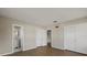 Bedroom with wood-look flooring, two closets, and an ensuite bathroom at 106 Aurora E St, Venice, FL 34285