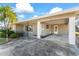 Home's entrance with covered porch and carport at 106 Aurora E St, Venice, FL 34285