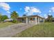 Inviting home with covered parking, palm trees, and a well-kept lawn at 106 Aurora E St, Venice, FL 34285