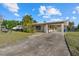 Charming single-story home with covered carport and tropical landscaping at 106 Aurora E St, Venice, FL 34285