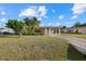 Well-maintained single-story home featuring a covered carport and mature landscaping at 106 Aurora E St, Venice, FL 34285