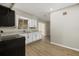 Bright kitchen features white cabinets, granite countertops, modern appliances and wood-look flooring at 106 Aurora E St, Venice, FL 34285