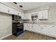 Updated kitchen featuring white cabinets and modern appliances at 106 Aurora E St, Venice, FL 34285
