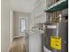 Functional laundry room with washer, dryer, and shelving for storage at 106 Aurora E St, Venice, FL 34285