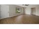 Bright living room featuring wood-look floors and large windows at 106 Aurora E St, Venice, FL 34285