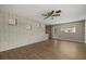 Spacious living area with wood-look flooring and textured brick half-wall at 106 Aurora E St, Venice, FL 34285