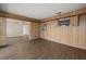 Spacious living room with wood paneled walls and wood grain flooring at 106 Aurora E St, Venice, FL 34285