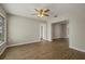 Open-concept living room featuring a ceiling fan, wood-look flooring and view to other rooms at 106 Aurora E St, Venice, FL 34285