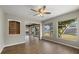 Living room featuring a ceiling fan, wood-look flooring and windows to the exterior at 106 Aurora E St, Venice, FL 34285
