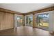 Sunroom featuring wood paneling, wood-look flooring and sliding glass doors to the patio at 106 Aurora E St, Venice, FL 34285