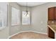 Bright breakfast nook with window seating and chandelier at 11202 Paradise Point Way, New Port Richey, FL 34654