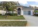 Single-story house with a screened porch and landscaped lawn at 11202 Paradise Point Way, New Port Richey, FL 34654