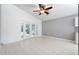 Gathering room with tile floors, ceiling fan and access to the backyard at 11423 Tee Time Cir, New Port Richey, FL 34654