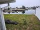 Grass yard with canal view, tarp on the ground at 12825 1St Isle, Hudson, FL 34667