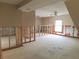 Unfinished bedroom with exposed framing and new flooring at 14310 Guava St, Hudson, FL 34667