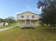 Two-story house with a balcony and exterior stairs at 14310 Guava St, Hudson, FL 34667