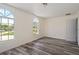 Bright bedroom with arched windows and wood-look floors at 15806 Adobe Dr, Hudson, FL 34667