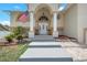 Front entryway with stairs leading to the porch at 15806 Adobe Dr, Hudson, FL 34667