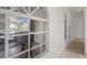 Bright hallway with arch window and wood-look floors at 15806 Adobe Dr, Hudson, FL 34667