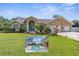 Single-story home with two-car garage and lush landscaping at 18242 Autumn Lake Blvd, Hudson, FL 34667