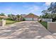 Attractive single-Gathering home with a well-maintained lawn, long driveway, and a three-car garage at 18242 Autumn Lake Blvd, Hudson, FL 34667