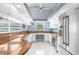 Bright kitchen featuring stainless steel appliances, a peninsula island, and tile backsplash at 18242 Autumn Lake Blvd, Hudson, FL 34667