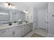 Double vanity bathroom with modern fixtures and large mirror at 19293 Ship Wheel Way, Land O Lakes, FL 34638