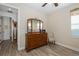 Bright bedroom with wood dresser and a view of hallway at 19293 Ship Wheel Way, Land O Lakes, FL 34638