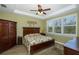 Bright bedroom featuring a king-size bed and wood floors at 19293 Ship Wheel Way, Land O Lakes, FL 34638