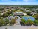 Aerial view of community with pool, tennis courts, and homes at 2518 Grey Dove Ct, Holiday, FL 34691