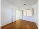 Bedroom with wood flooring and double doors leading to another room at 2518 Grey Dove Ct, Holiday, FL 34691