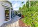 Landscaped backyard with brick path and lush greenery at 2647 Royal Ridge Dr, Spring Hill, FL 34606