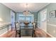 Elegant dining room with glass-top table and hardwood floors at 2647 Royal Ridge Dr, Spring Hill, FL 34606