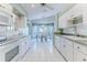 Bright kitchen features white cabinets, a breakfast nook, and tile floors at 2647 Royal Ridge Dr, Spring Hill, FL 34606