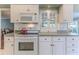 White kitchen cabinets, granite counters, and modern appliances at 2647 Royal Ridge Dr, Spring Hill, FL 34606