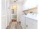 Well-lit laundry room with a sink and storage at 2647 Royal Ridge Dr, Spring Hill, FL 34606