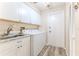 Laundry room with washer, dryer, cabinets and sink at 2647 Royal Ridge Dr, Spring Hill, FL 34606