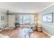 Bright living room with bay window, hardwood floors, and comfortable seating at 2647 Royal Ridge Dr, Spring Hill, FL 34606