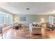 Bright living room with hardwood floors, and a view into dining room at 2647 Royal Ridge Dr, Spring Hill, FL 34606