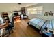 Well-lit bedroom with wood floors and built-in shelving at 3322 Fairmount Dr, Holiday, FL 34691