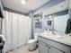 Bathroom with gray vanity, white toilet and shower/tub combo at 3337 Autumn Amber Dr, Spring Hill, FL 34609