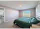 Comfortable bedroom with green bedding and carpet flooring at 3337 Autumn Amber Dr, Spring Hill, FL 34609