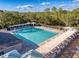 Resort-style community pool with shaded seating at 3337 Autumn Amber Dr, Spring Hill, FL 34609