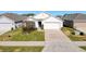 Charming single-story home with a well-manicured lawn and a two-car garage on a sunny day at 3337 Autumn Amber Dr, Spring Hill, FL 34609