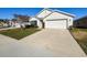 Charming one-story home featuring a well-manicured lawn and a two-car garage at 3337 Autumn Amber Dr, Spring Hill, FL 34609