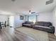 Spacious living room with gray sectional sofa and ceiling fan at 3337 Autumn Amber Dr, Spring Hill, FL 34609