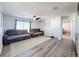 Living room with sectional sofa, rug, and access to bedroom at 3337 Autumn Amber Dr, Spring Hill, FL 34609