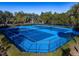 Two blue tennis courts with nets and fencing at 3337 Autumn Amber Dr, Spring Hill, FL 34609