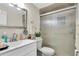 Bathroom features a vanity with a sink, a toilet, and a shower with sliding glass doors at 3337 Darlington Rd, Holiday, FL 34691